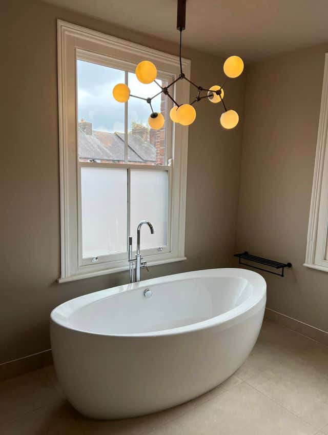 Traditional freestanding bathtub by the window installed by Plumb Yorkshire.