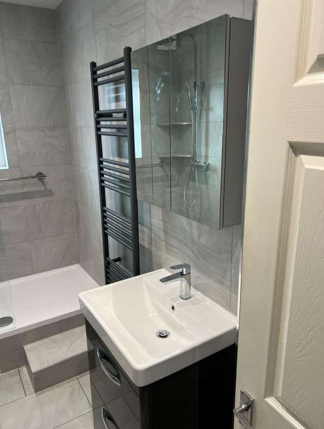 Modern sink basin in grey tiled bathroom by Plumb Yorkshire.