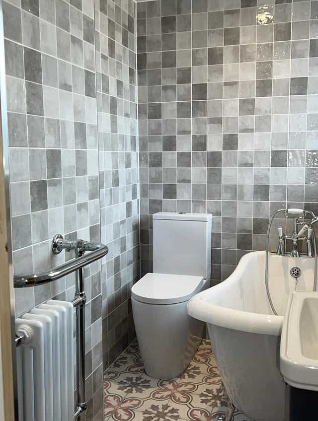 Traditional bathroom gray tiles patterned floor by Plumb Yorkshire.
