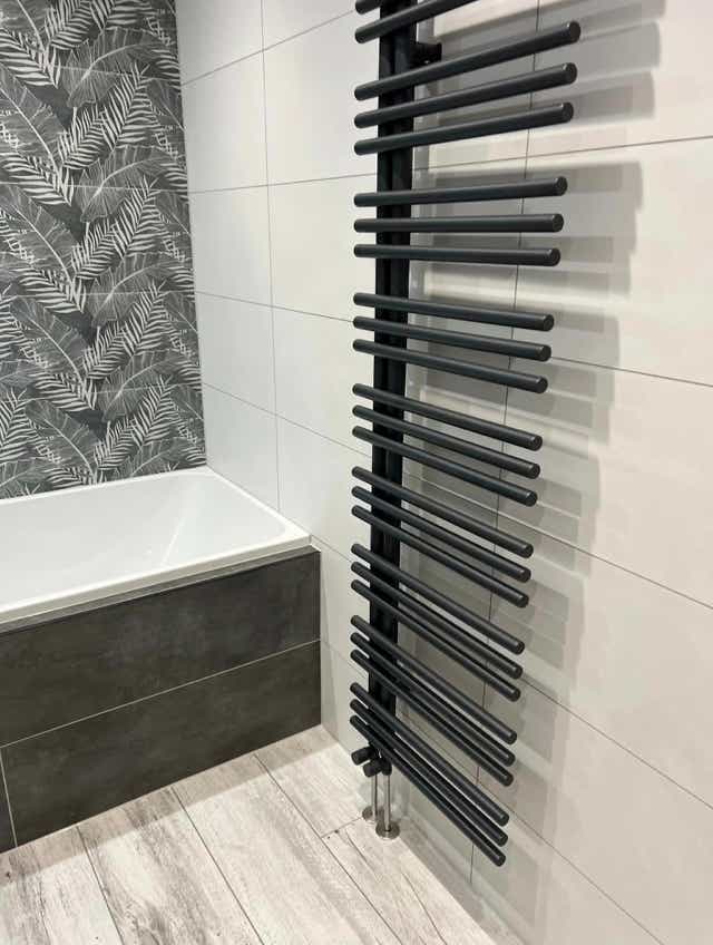 Chic bathroom vanity under light by Plumb Yorkshire.