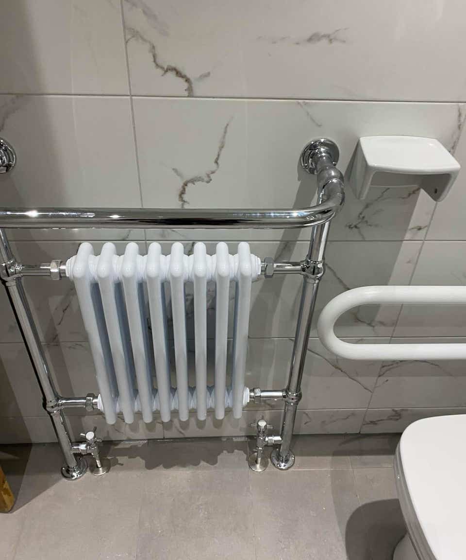 Mobility fixtures around a toilet and a radiator in a mobility bathroom by Plumb Yorkshire Ltd.
