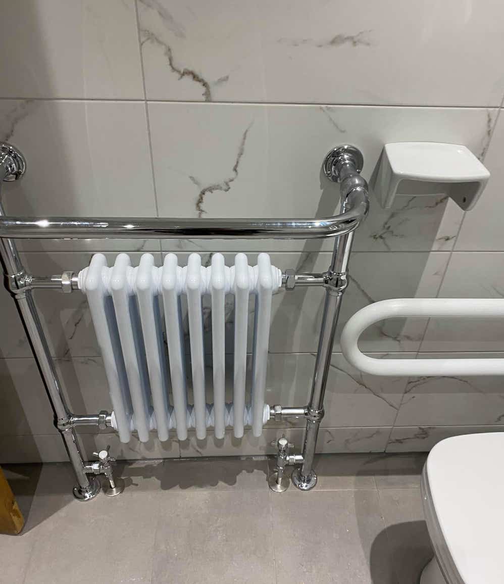 Mobility fixtures around a toilet and a radiator in a mobility bathroom by Plumb Yorkshire Ltd.