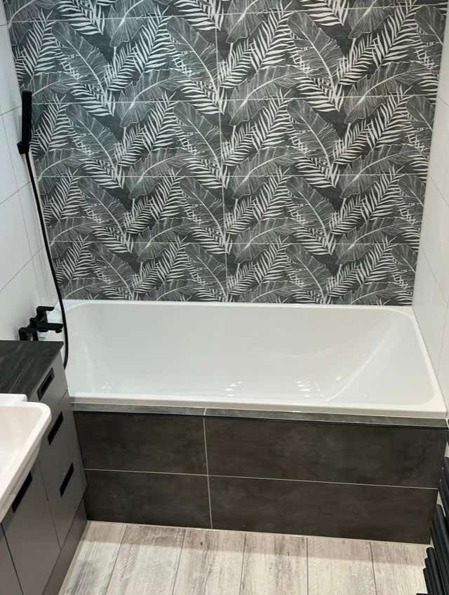 Bathroom leafy tile accent wall by Plumb Yorkshire.