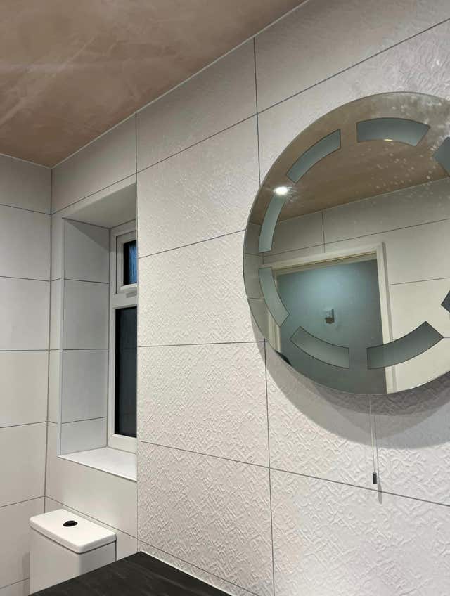 Bathroom leafy tile accent wall by Plumb Yorkshire.