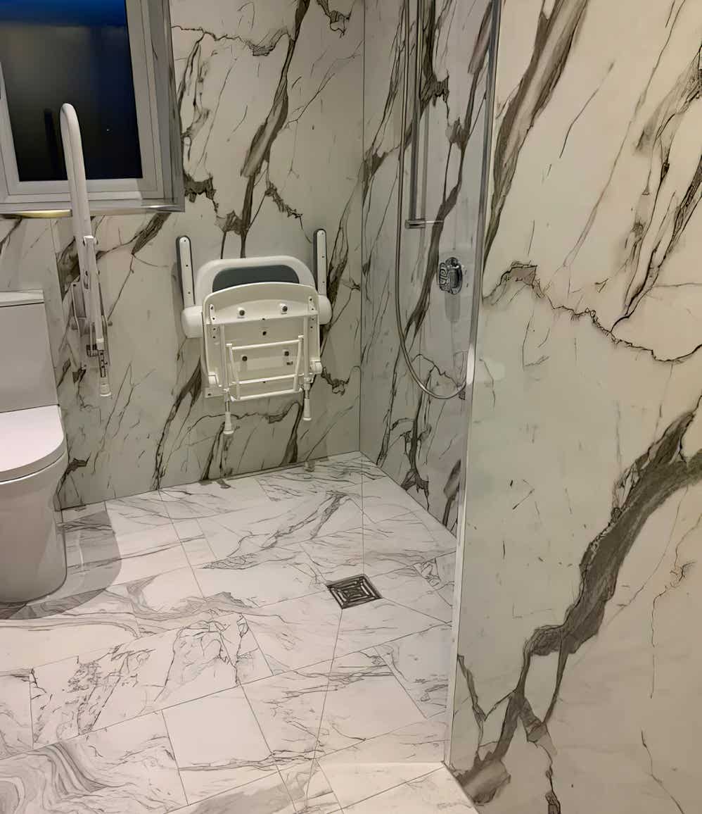 Modern wet wall panel design in a mobility bathroom built by Plumb Yorkshire Ltd.