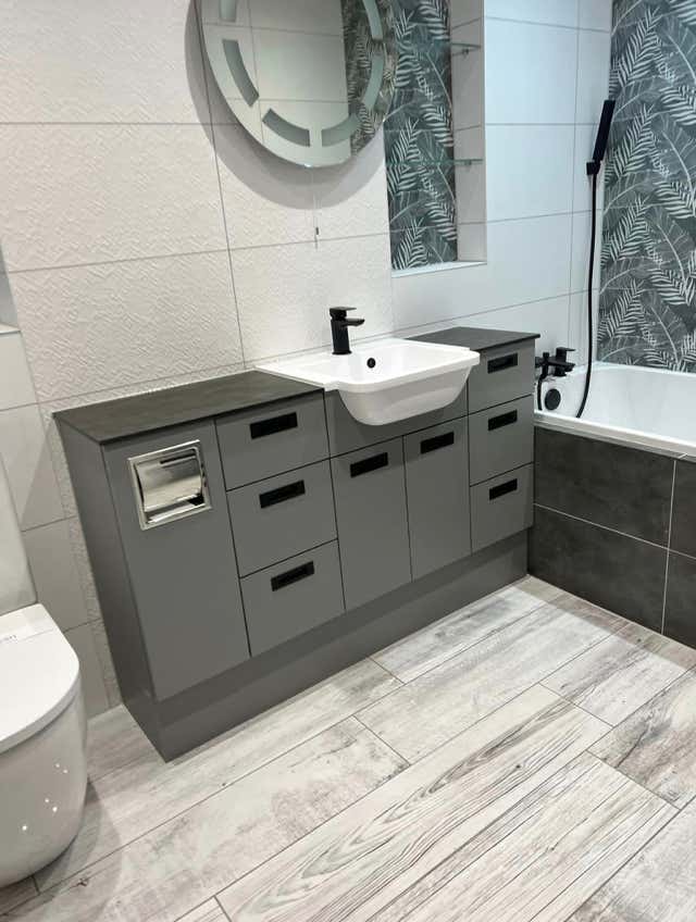Spacious grey vanity bathroom setup by Plumb Yorkshire.