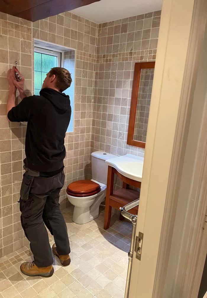 Image of Plumb Yorkshire Ltd. team member adjusting fittings.